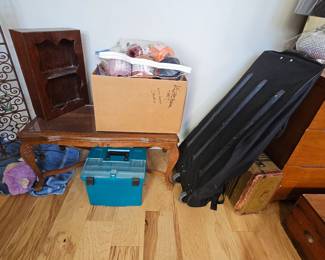 vintage suitcase, rollering duffle bag, vintage wood cocktail table, vintage curio display, skeins and skeins crochet yarn