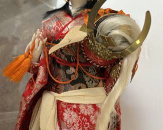 Doll Representing Princess Yaegakihime holding a stolen Kabuto helmet her fiance must retrieve  ( Samurai Lord Date  Masasume') Believed to symbolize strength & Protection in a home 