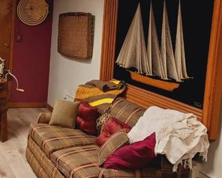 Sleeper and matching chair and ottoman, enormous ship string art and frame. Big basket on the wall.
