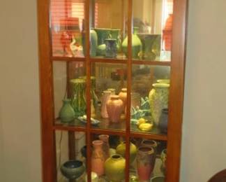Pair of Mission Style Lighted Curio Cabinets with Stained Glass Top, Mirrored Back and Sliding Door. Large Collection of Arts and Crafts era Art Pottery Vases/Flower Frogs