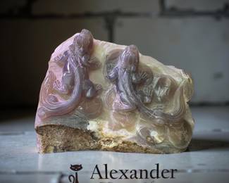 hand-carved sculpture made from agate featuring relief carvings