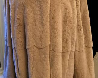 Another reversible coat! Sheared fur coat reverses to a beige raincoat! Warm on the inside, protective on the outside!