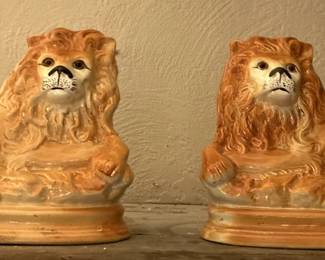Pair of antique Staffordshire lions with glass eyes