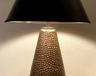 One of two hammered metal lamps with black shades