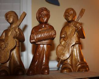 Hand carved wood minstrels:  one w/accordion/and two w/bass guitar 