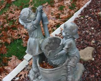 Yard art:  Girl and boy w/bucket
