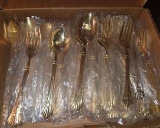 Unused set of gold flatware