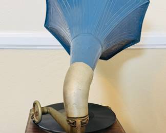 Antique Gramaphone uses a needle that traces a groove on a spinning disc, with the vibrations then acoustically amplified through the large horn.