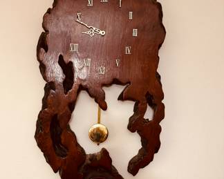 vintage handcrafted redwood burl wood pendulum wall clock with Roman numerals.