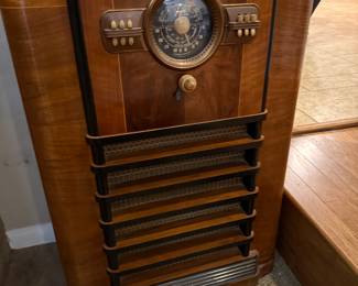 vintage Zenith Model 10S464 console radio. This Art Deco-inspired floor model radio was manufactured in 1940 and features a wooden cabinet and a distinctive black "shutter dial".