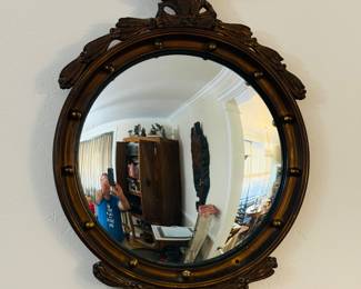 American Federal Style Giltwood Convex Bullseye Mirror.With its boldly reeded frame and elegant eagle crest, this Federal-style convex mirror captures early American neoclassical style. The giltwood surface has developed a warm patina over time, while the convex mirror adds drama and dimension to any wall.