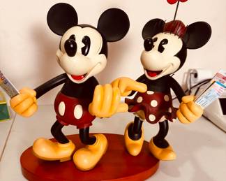 Mickey and Minnie Mouse figurine set, a collectible item for Disney fans. It appears to be a hand-painted statue, possibly made of resin or porcelain, given its glossy finish and detailed sculpting.