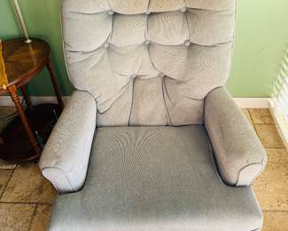 upholstered swivel rocker chair in a light grey fabric.