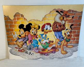 This is an original edition art print titled Mickey & Friends: Brick Wall.
The print features Mickey Mouse, Minnie Mouse, Donald Duck, Goofy, and Pluto in a street-style setting.