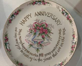 This is a collectible decorative plate with "Happy Anniversary" text and a floral bell design.