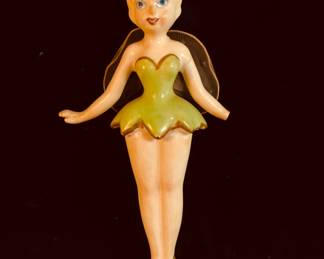 Tinker Bell from Peter Pan.
It is crafted from resin and features a wind-up motion.The piece is considered a collectible item for Disney enthusiasts.
The ornament is in its original state with minimal wear, no chips, cracks, or repairs.