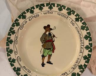 This is a Royal Doulton series ware collector plate featuring the quote "They who won't be counselled can't be helped".
The design belongs to a series often referred to as "Cavaliers" or "Benjamin Franklin" plates.