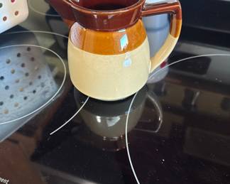 Vintage brown and tan two-tone stoneware creamer.