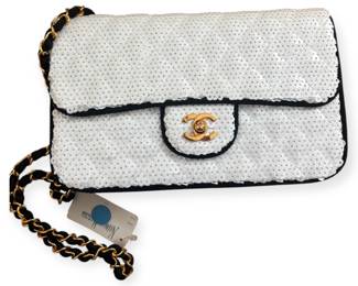 CHANEL 1990s Vintage White Sequin Shoulder Bag with Black Fabric Edging & Gold Chain Strap with Fabric Rope

✨ Description:
Discover vintage elegance with this authentic 1990s Chanel White Sequin Shoulder Bag featuring shimmering white sequins bordered by sleek black fabric edging along the sides and a luxurious black fabric interior. The signature gold-tone chain strap is intricately woven with black fabric rope, adding a tactile, refined contrast true to Chanel’s craftsmanship.

Finished with the iconic gold CC turn-lock closure, this bag combines timeless Parisian style with collectible vintage appeal. Mint condition with original tag and authenticity card included.