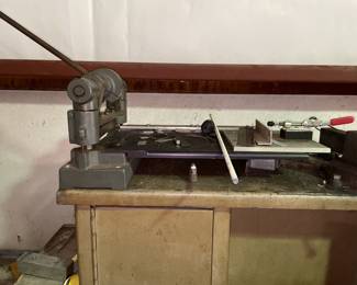 Metal cutter with two vices that are attached to the bench