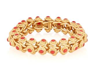 153
An 18K Gold and Coral Bracelet
Featuring interlocking gold links accented by round red coral cabochons set in a braided mount, Italy

Length: 8 1/2 in, width: 5/8 in.
82.5 grams gross
Estimate: $9,000 - $12,000