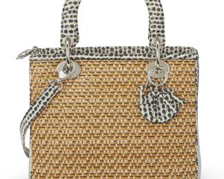 276
Christian Dior: A Lady Dior Woven Straw and Watersnake Medium Tote, 2014
Circa April 2014, Italy
Marked to interior tag: Christian Dior / Paris / Made in Italy; marked verso: 02-MA-0144
A two-handled handbag with a woven straw-style body with black and white printed watersnake trim, handles, and detachable shoulder strap, with CD branded silver-toned metal hardware and D.I.O.R. charms, the interior with black leather lining and one zip pocket

8 x 9 1/2 x 4 1/2 in.; handle drop: 4 in.; strap drop: 17 in.
Estimate: $1,000 - $1,500