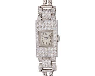 242
Van Cleef & Arpels: An Art Deco Platinum and Diamond Watch
Dial: 9.70 mm, square with Arabic hour markers
Case: 13.90 mm, accented by single-cut diamonds weighing approximately 3.00 carats
Case number: 27285
Closure: platinum zipper bracelet with jewelry clasp
Signed: Van Cleef & Arpels case back with French assay marks

Inner circumference: 6 1/2 in.
27.3 grams gross
Estimate: $10,000 - $15,000