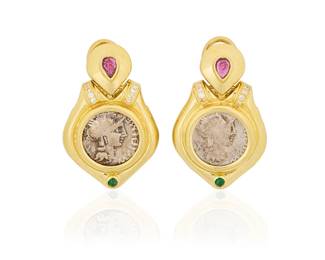 75
A Pair of 18K Gold, Coin and Gem-Set Earclips
Featuring ancient style silver coins, accented by pear-shaped garnets, round emerald cabochons and finished with round diamonds, with Italian assay marks
2 pieces

Measures: 1 7/8 x 7/8 in.
27.6 grams gross
Estimate: $1,200 - $1,800