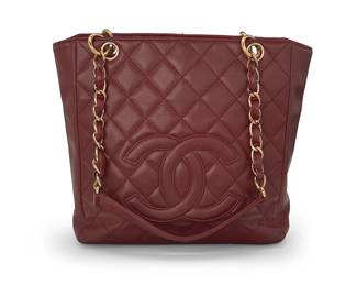 274
CHANEL: A Dark Red Caviar Leather Petit Shopping Tote, 2004-2005
Circa 2004-05, Italy
Marked to interior red leather tag: Chanel / ® / Made in Italy; Authentication tag: No. 9300788
The quilted burgundy leather tote with gold-toned hardware, two leather chain handles, and exterior pocket, with red fabric lining, magnetic tab closure, and two interior pockets, one zipped

9 1/2 x 9 5/8 x 3 1/4 in. / 24 x 24.5 x 8.5 cm; handle drop: 10 in. / 25.5 cm
Estimate: $1,000 - $1,500