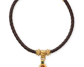 71
Joan Boyce: An 18K Gold and Gem-Set Necklace
Featuring a braided brown leather collar with gold granulation accents suspending a watch key style pendant with an oval citrine cabochon and a square-cut green tourmaline necklace, signed JBC

Collar: 13 1/2-17in.
49.8 grams gross
Estimate: $2,500 - $3,500