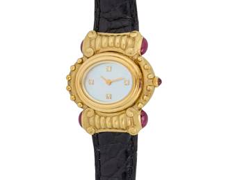 68
Joan Boyce: An 18K Gold and Gem-Set watch
Dial: 16.00 mm, oval mother-of-pearl dial with diamond set hour markers
Case: 30.00 mm, accented by four oval ruby cabochons
Case number:  106
Closure: black leather clasp with a gold buckle clasp
Signed: case

Inner circumference: 6 1/4 - 7 3/4 in.
34.4 grams gross
Estimate: $3,500 - $5,500