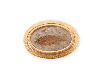 186
An 18K Gold and Fossil Brooch
Centering an ancient fish fossil in matrix, set in a textured brushed 18k gold frame

Measures: 1 3/4 x 1 1/4 in.
21.4 grams
Estimate: $700 - $1,000