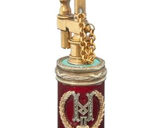 163
Fabergé: An Enameled Russian Silver Cigarette Lighter
A cylindrical lighter of vermeil silver and 14K gold with red and pale blue guilloché enamel, featuring a gold laurel wreath and Cyrillic initial of Tsar Nicholas II with rosecut diamonds, with a brass strike fitting with garnet and red glass accents, marked to base for Fabergé, with Russian Kokoshnick assay, silver, and maker's mark

Measures: 3 3/4 in. x 1 1/8 in. Dia.
97.9 grams gross
Estimate: $4,000 - $6,000