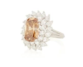 

Back to catalog
122
A Platinum, Fancy Deep Brown-Yellow Diamond and Diamond Ring
Centering a cushion brilliant-cut Fancy Deep Brown-Yellow weighing 4.38 carats, encircled by two rows of pear-shaped diamonds weighing approximately 2.50 carats, no.10841, 7335

Size: 6 3/4
10.9 grams gross

Accompanied by a GIA Report numbered #5232533478, dated May 26, 2025, stating the diamond as Natural with a color grade of Fancy Deep Brown-Yellow and a clarity grade of S12, no fluorescence.
Estimate: $18,000 - $25,000

