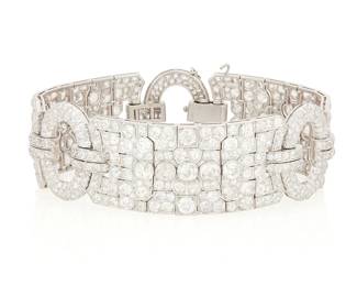 167
Raymond Yard: An Art Deco Platinum and Diamond Bracelet, c. 1930
Featuring three ornate panels connected by oval circular frames set with old European-cut and old Mine-cut diamonds weighing approximately 26.00 carats, signed Yard Inc.

Length: 7 1/2 in., Width: 7/8 in.
57.4 grams gross
Estimate: $35,000 - $55,000