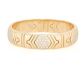 73
Bulgari: An 18K Gold and Diamond 'Parentesi' Cuff
Of a flexible design featuring a high polish gold chevron design accented by round diamonds weighing approximately 3.15 carats, signed Bulgari with Italian workshop marks

Inner circumference: 6 1/2 in.
70.0 grams gross
Estimate: $12,000 - $18,000