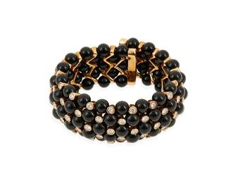 20
An 18K Gold, Onyx and Diamond Bracelet
Of a flexible cuff design featuring five rows of round onyx beads accented by round diamonds weighing approximately 4.25 carats

Measures: 6 1/2 in.
112.0 grams gross
Estimate: $4,000 - $6,000