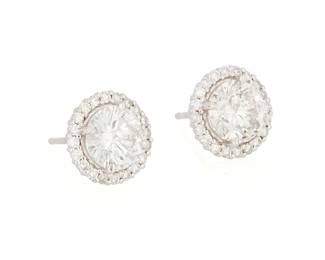 208
A Pair of 18K White Gold and Diamond Stud Earrings
Centering two round diamonds weighing approximately 1.32 and 1.18 carats, encircled by round diamonds weighing approximately 0.37 carat total
2 pieces

Measures: 3/8 in.
2.7 grams gross
Estimate: $2,000 - $3,000