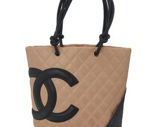 275
CHANEL: A Ligne Cambon Small Tote, 2004-2005
Circa 2004-2005, Italy
Marked to interior black leather tag: Chanel / ® / Made in Italy; Authenticity tag: No. 9313092
The tan and black smooth quilted leather tote with black leather knotted cord handles, silver-toned hadware, exterior pocket, and branded CC black fabric lining with zip top closure and one zipped interior pocket

9 3/4 x 8 x 4 1/2 in. / 25 x 20.5 x 11.5 cm; handle drop: 7 in. / 18 cm
Estimate: $700 - $900