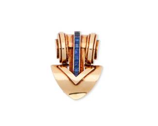 2
Cartier: A 14K Gold and Sapphire Clip/Brooch
Of a spade motif, featuring rolling design gold accents centering a band of channel set sapphires, signed Cartier, no.4548

Measures: 1 1/2 x 1 in.
14.2 grams gross
Estimate: $1,800 - $2,500