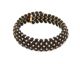 19
An 18K Gold, Onyx and Diamond Collar Necklace
Of a flexible design featuring five rows of round onyx beads accented by round diamonds weighing approximately 8.70 carats, with makers mark

Inner circumference: 13 in.
223.4 grams gross
Estimate: $8,000 - $12,000