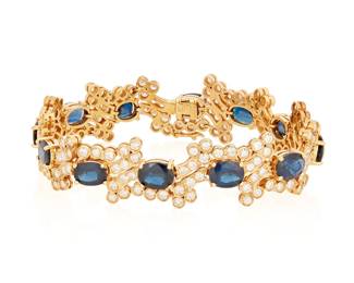 177
A 14K Gold, Sapphire and Diamond Bracelet
Of an ornate design centering twelve oval sapphires weighing approximately 14.00 carats, accented by round diamonds weighing approximately 4.60 carats

Length: 6 1/4 in., Width: 1/2 in.
22.6 grams
Estimate: $2,500 - $3,500