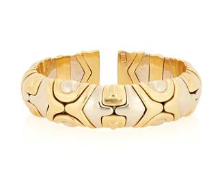 182
An 18K Bi-Color Gold Cuff
Of a flexible design featuring geometric elements of yellow and white gold

Length: 5 1/2 in., Width: 1/4 in., flexible
88.3 grams gross
Estimate: $6,000 - $8,000