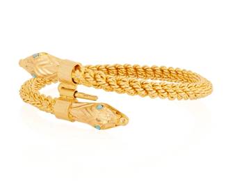 187
A 22K Gold Snake Cuff
Featuring two bypassing terminals of a snake head design finished with four round blue glass cabochons as eyes

Inner Circumference: 7 in.
52.3 grams gross
Estimate: $4,000 - $6,000