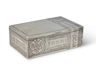 159
A Russian Silver Trompe L'oeil Cigarette Case
Featuring chased designs to the lid and sides engraved to imitate tobacco paper tax bands, circa 1885, with Imperial Russian assay and maker's marks, and for 875 silver

Measures: 3 1/2 x 2 1/4 x 1 1/8 in.
138.9 grams
Estimate: $800 - $1,200