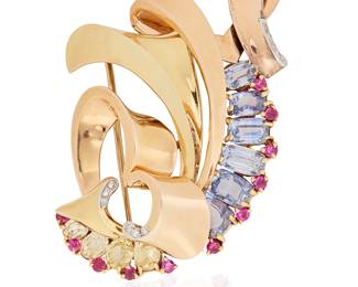 195
Trabert & Hoeffer- Mauboussin: A Tri-Color Gold, Gem-Set and Diamond Clip/Brooch
Of a swirling ribbon design featuring yellow and gold, accented by six rectangular cushion-cut sapphire, four oval yellow sapphires and eleven round rubies, finished with eleven single-cut diamonds, signed Trabert & Hoeffer, Mauboussin, Reflection, executed for Blanche Martin

Measures: 2 3/4 x 1 3/4 in.
27.6 grams gross
Estimate: $6,000 - $8,000