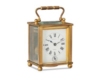 240
A Couaillet Frères carriage alarm clock for Tiffany & Co.
Late 19th/early 20th century
Dial marked: Tiffany & Co. / France; movement marked: COUAILLET FRERES / 11 ELEVEN JEWELS; door incised: 2074; and twice impressed: 06
The two-movement clock with enameled metal dial bearing Roman numeral hour track above a subsidiary alarm dial bearing Arabic number track, with bell striker, set in a glazed brass case with upper swing handle, all housed in the original velvet-lined fitted box with winding key
Clock store: 3.875" H x 2.875" W x 2.5" D; Box: 4.5" H x 3.5" W x 3.875" D
Estimate: $800 - $1,200