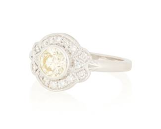 43
An 18K White Gold and Diamond Ring
Centering a round diamond weighing approximately 1.00 carats accented by sixteen round diamonds

Size: 7
5.3 grams gross
Estimate: $1,200 - $1,800