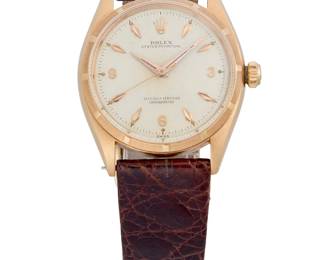 263
Rolex: An 18K Gold 'Oyster Perpetual' Watch
Dial: 28.00 mm round with Panerai hour markers
Model: Oyster Perpetual
Case: 35.00
Case number:  270.6.48, 1431500 serial
Closure: brown leather strap with plated buckle clasp
Signed: Case and movement

Inner circumference: 7 - 8 1/2 in.
48.1 grams gross
Estimate: $2,000 - $3,000
