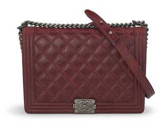 272
CHANEL: A Large Burgundy Leather Crossbody Boy Flap Bag, 2013
Circa 2013, Italy
Marked to interior tag: Chanel / ® / Made in Italy; Carte D'Authenticité and interior tag: No. 18309026
The distressed leather crossbody bag with quilted and embossed leather front flap and back, branded ruthenium distressed gunmetal hardware including a CC spring clasp, chain and leather long strap, and with a black grosgrain lining and multiple pockets, with dust bag and box

8 x 12 x 3 1/2 in. / 20 x 30.5 x 9 cm; handle drop: 20 in. / 51 cm
Estimate: $2,000 - $3,000
